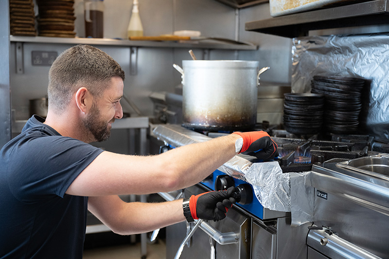 Gas engineer carrying out gas safety checks on catering equipment