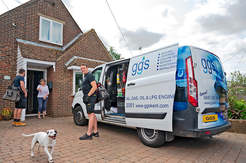 Domestic gas engineers visiting a customer